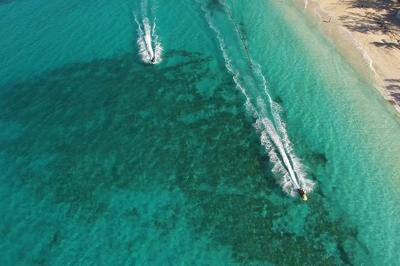 Aerial view of jet skis on the ocean.